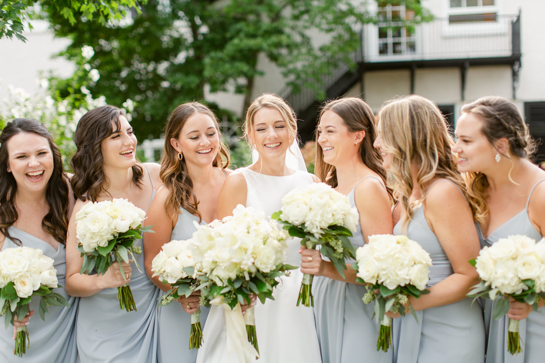Bride and bridesmaids in blue dresses with white bouquets