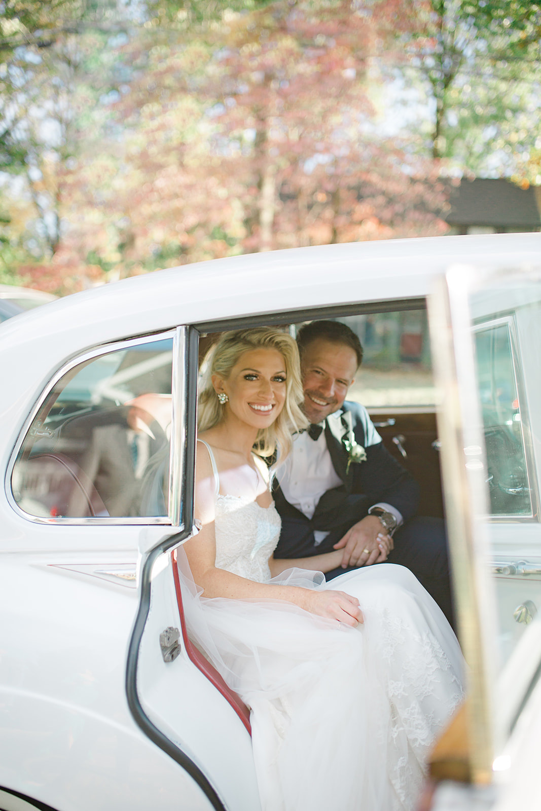 Bride and groom in classic white Rolls Royce