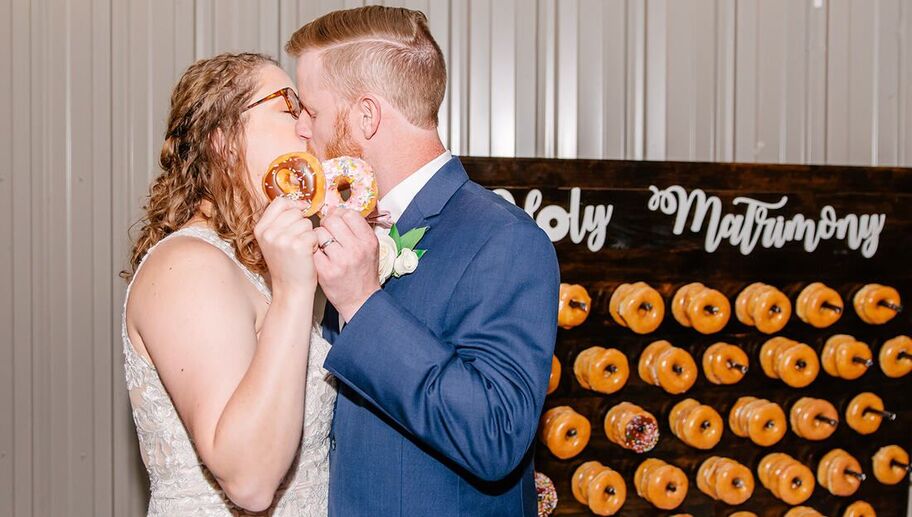 Kissing bride and groom with donut wall