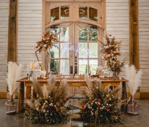 Sweetheart headtable with dried florals, pampas grass, and neon