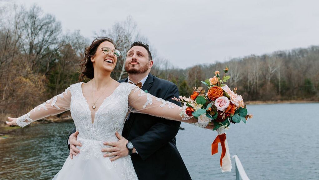 Bride and groom portrait on lake dock