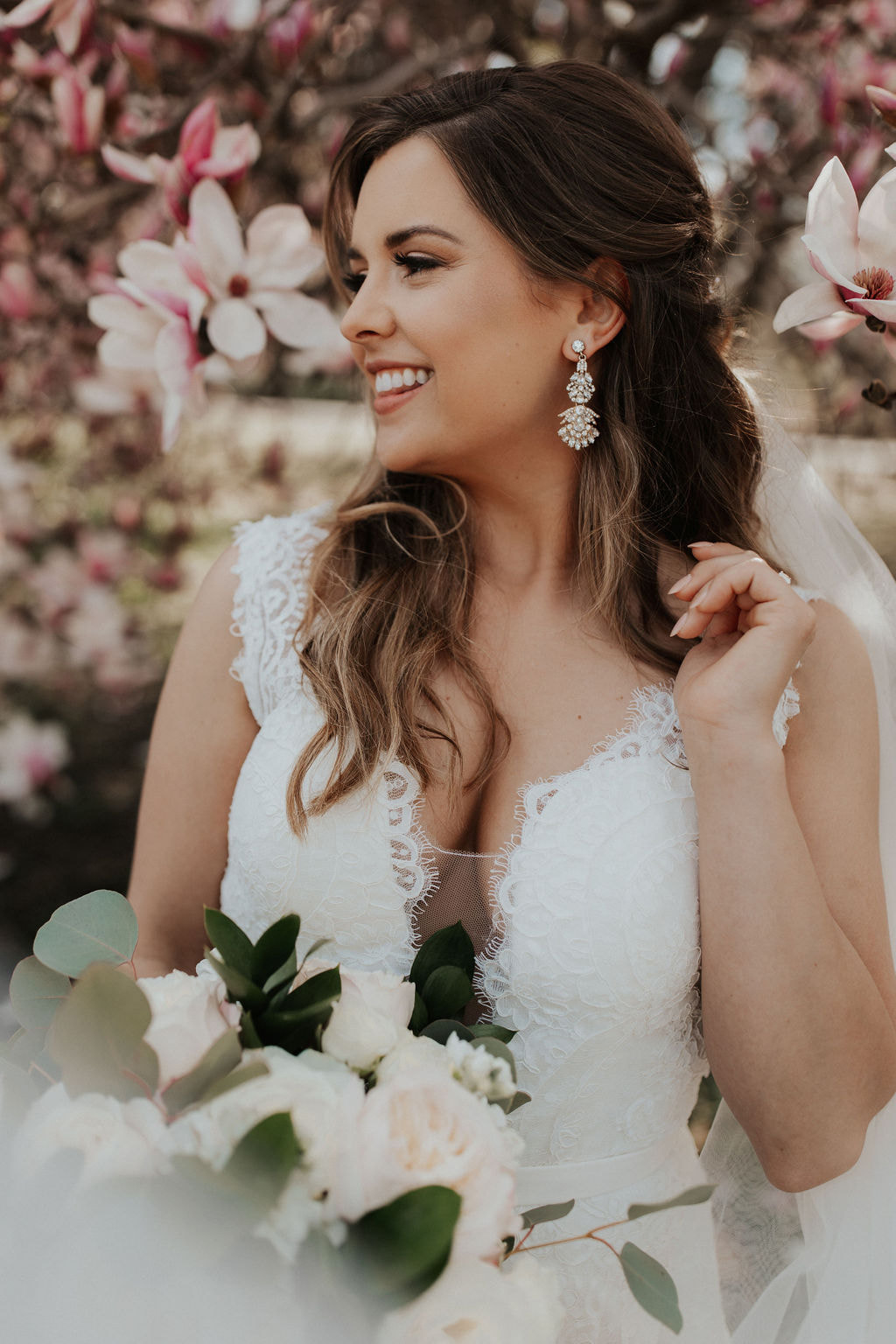Bridal portrait at blooming cherry blossom tree