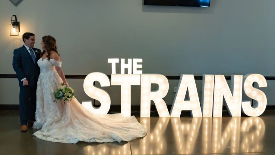 Large lit marquee letters with bride and groom