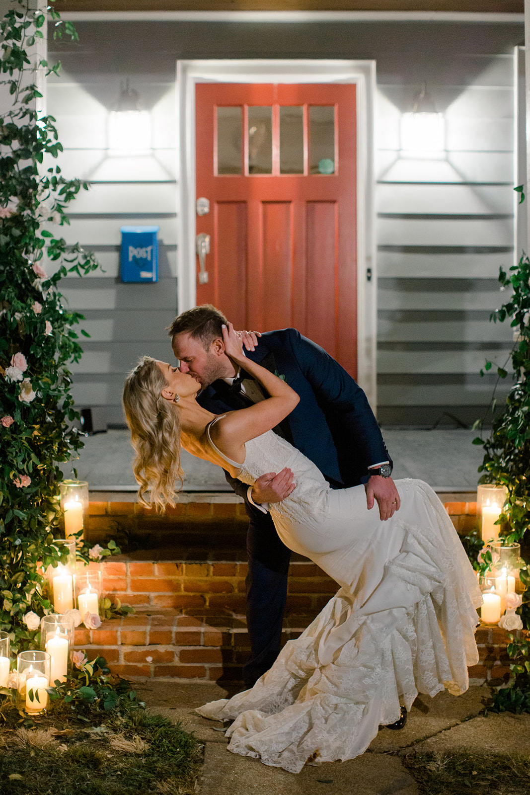 Dip kiss on stairs with greenery and candles
